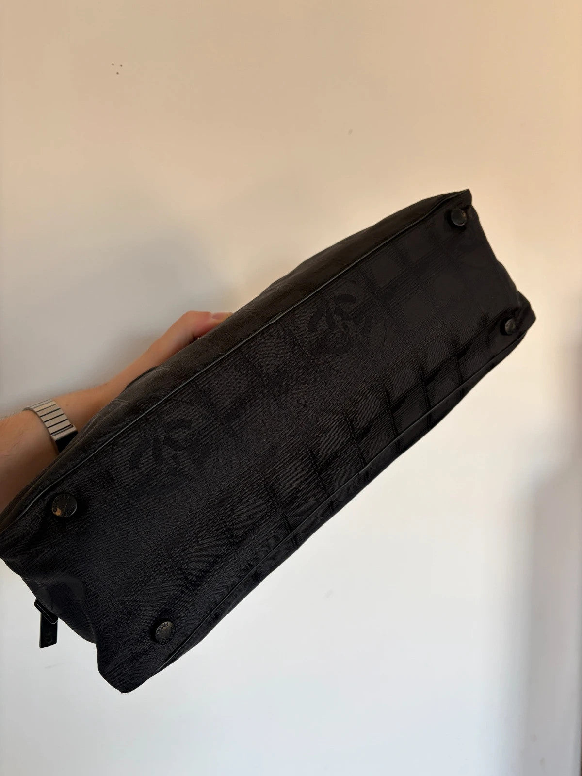 Chanel black handbag woven nylon jacquard with repeating CC monogram and leather trim.