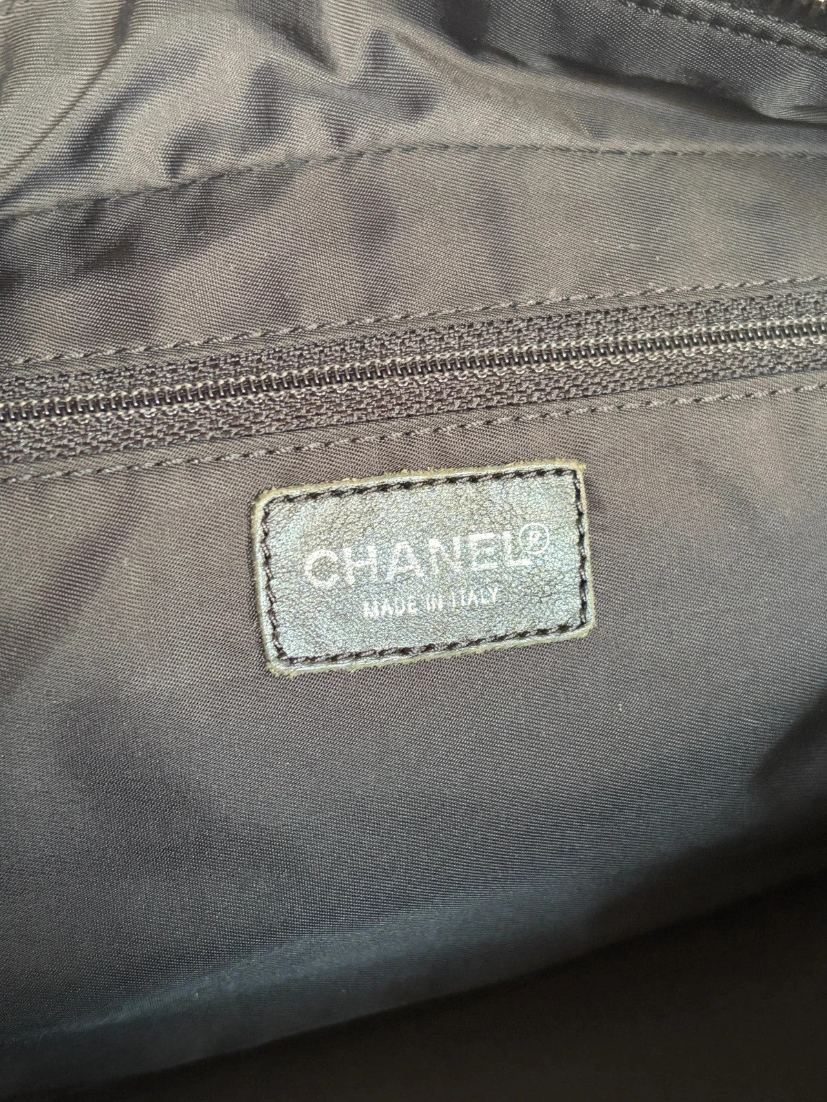 Chanel black handbag woven nylon jacquard with repeating CC monogram and leather trim.