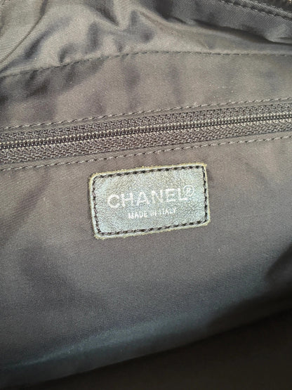 Chanel black handbag woven nylon jacquard with repeating CC monogram and leather trim.