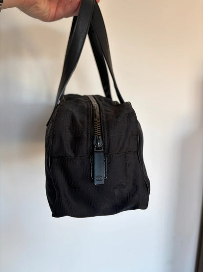 Chanel black handbag woven nylon jacquard with repeating CC monogram and leather trim.