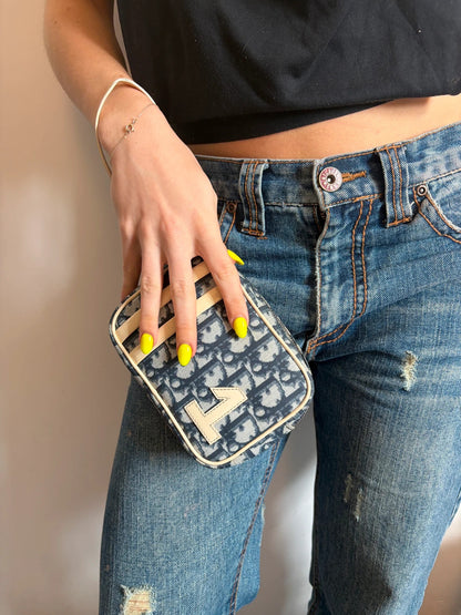 Dior cream and navy wristlet with Trotter monogram, patent leather appliqués, and silver zipper.