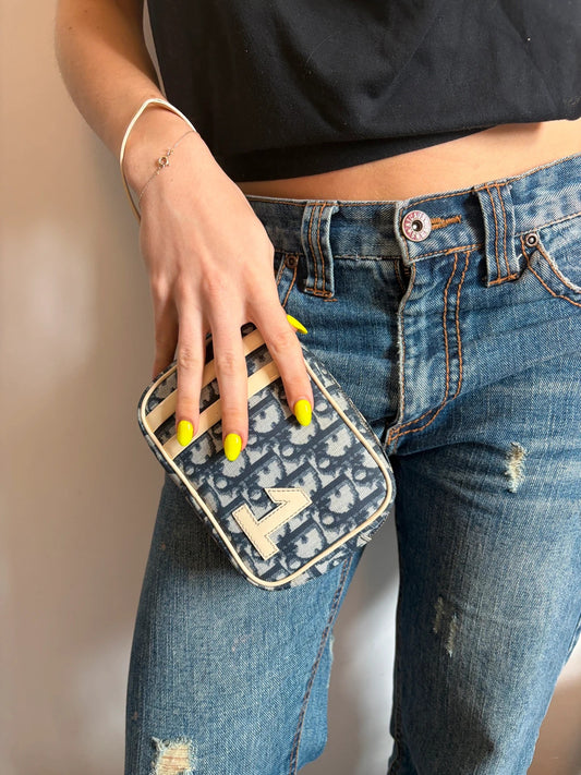 Dior cream and navy wristlet with Trotter monogram, patent leather appliqués, and silver zipper.