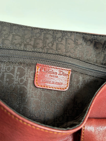 Christian Dior burgundy shoulder bag distressed calfskin leather with tan whipstitch and logo charms.