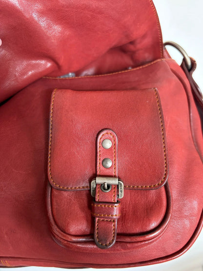 Christian Dior burgundy shoulder bag distressed calfskin leather with tan whipstitch and logo charms.
