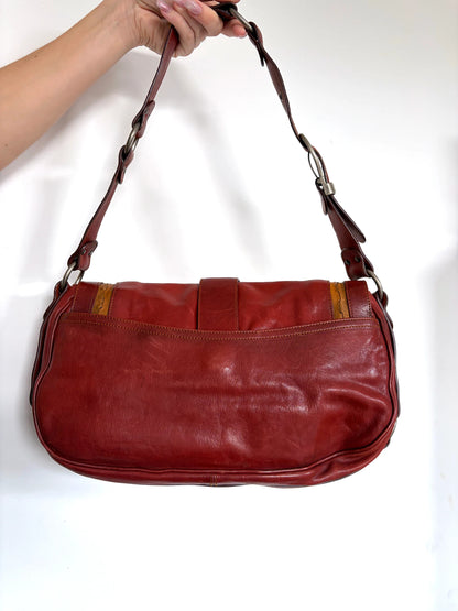 Christian Dior burgundy shoulder bag distressed calfskin leather with tan whipstitch and logo charms.