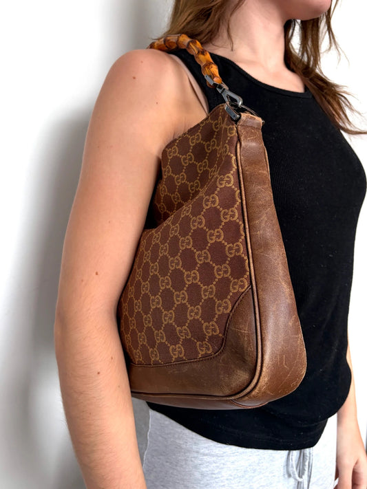 Gucci brown hobo bag with GG monogram canvas and bamboo handle, silver-tone hardware.