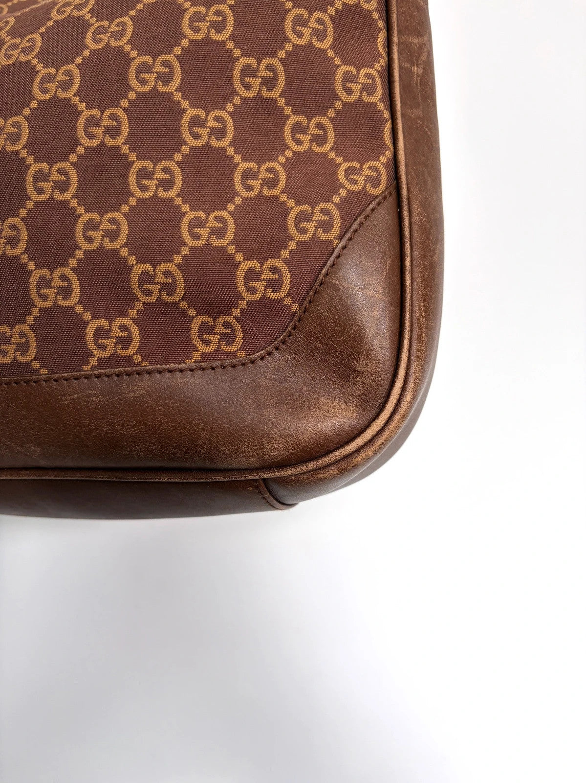 Gucci brown hobo bag with GG monogram canvas and bamboo handle, silver-tone hardware.