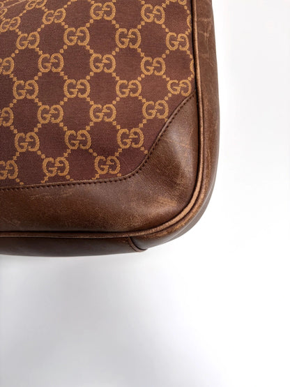 Gucci brown hobo bag with GG monogram canvas and bamboo handle, silver-tone hardware.