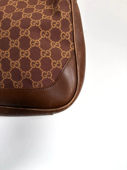 Gucci brown hobo bag with GG monogram canvas and bamboo handle, silver-tone hardware.