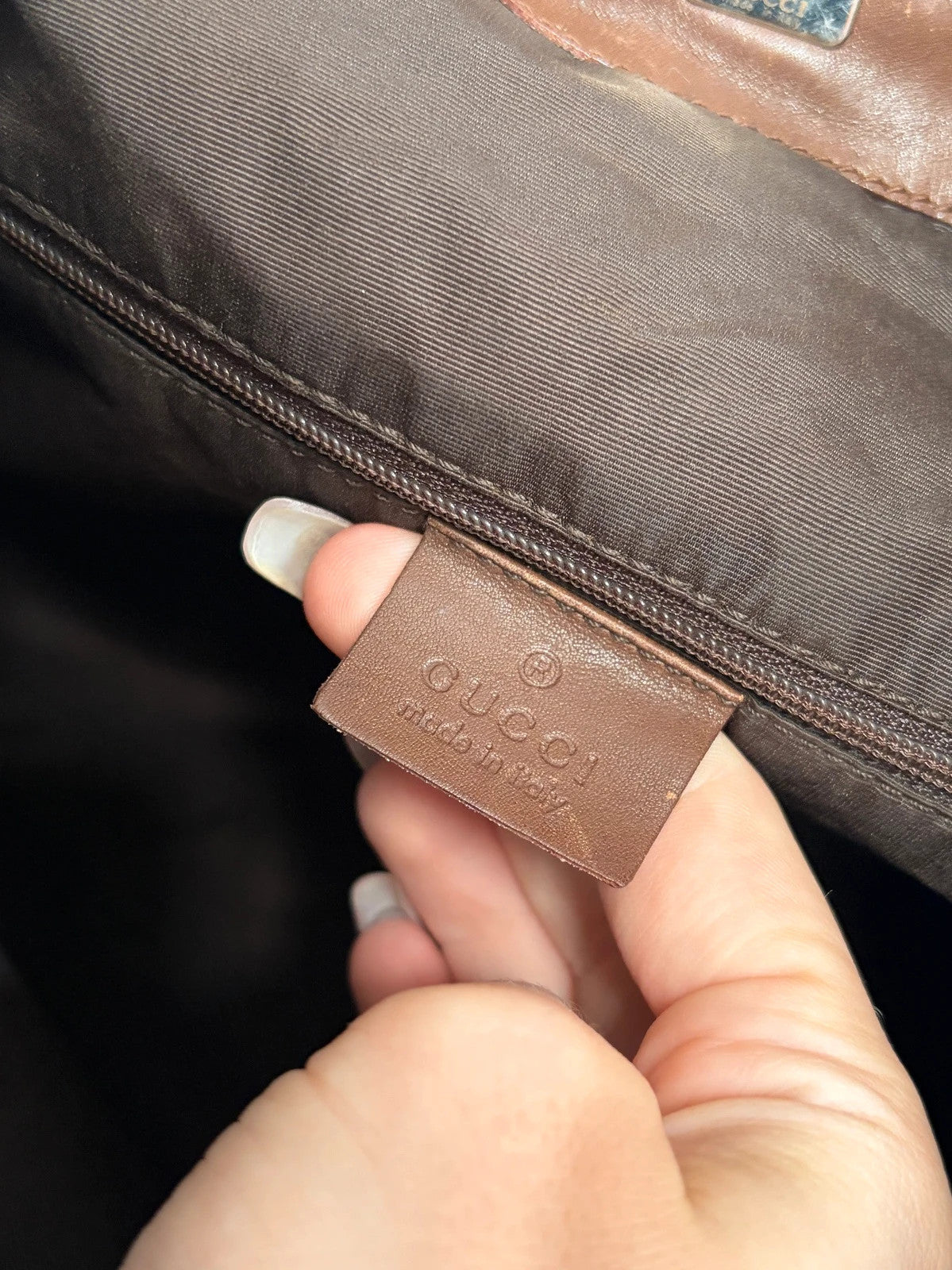 Gucci brown hobo bag with GG monogram canvas and bamboo handle, silver-tone hardware.