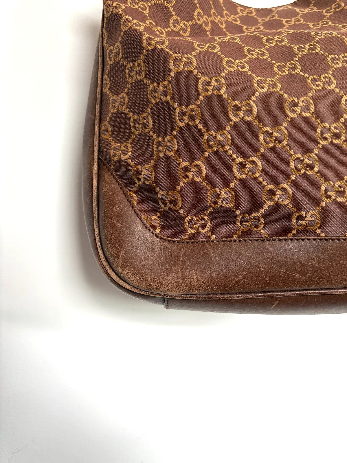 Gucci brown hobo bag with GG monogram canvas and bamboo handle, silver-tone hardware.