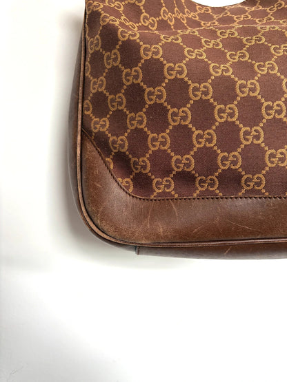 Gucci brown hobo bag with GG monogram canvas and bamboo handle, silver-tone hardware.