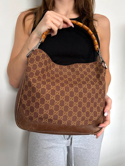 Gucci brown hobo bag with GG monogram canvas and bamboo handle, silver-tone hardware.
