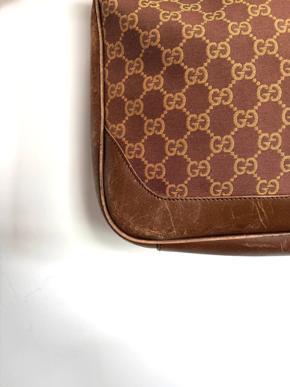 Gucci brown hobo bag with GG monogram canvas and bamboo handle, silver-tone hardware.