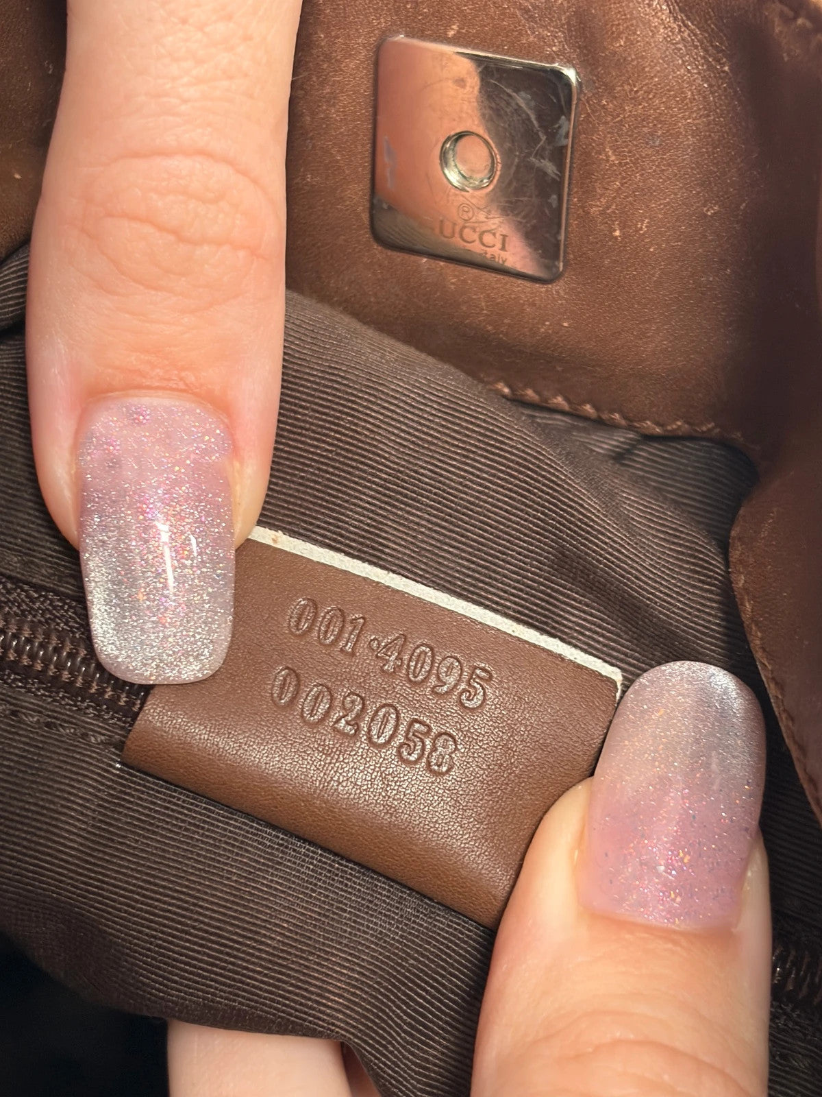 Gucci brown hobo bag with GG monogram canvas and bamboo handle, silver-tone hardware.