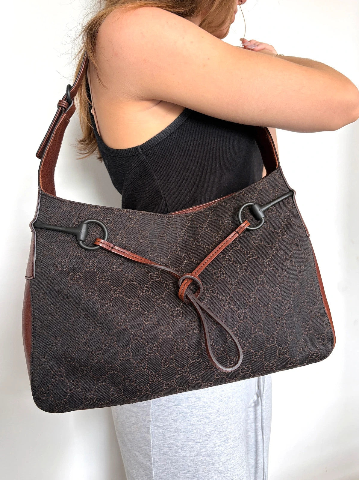 Gucci dark brown hobo bag with GG canvas, Horsebit hardware, and leather trim.