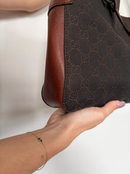 Gucci dark brown hobo bag with GG canvas, Horsebit hardware, and leather trim.