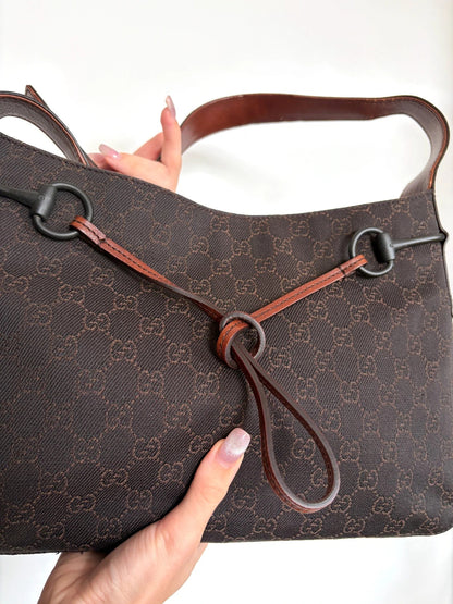 Gucci dark brown hobo bag with GG canvas, Horsebit hardware, and leather trim.