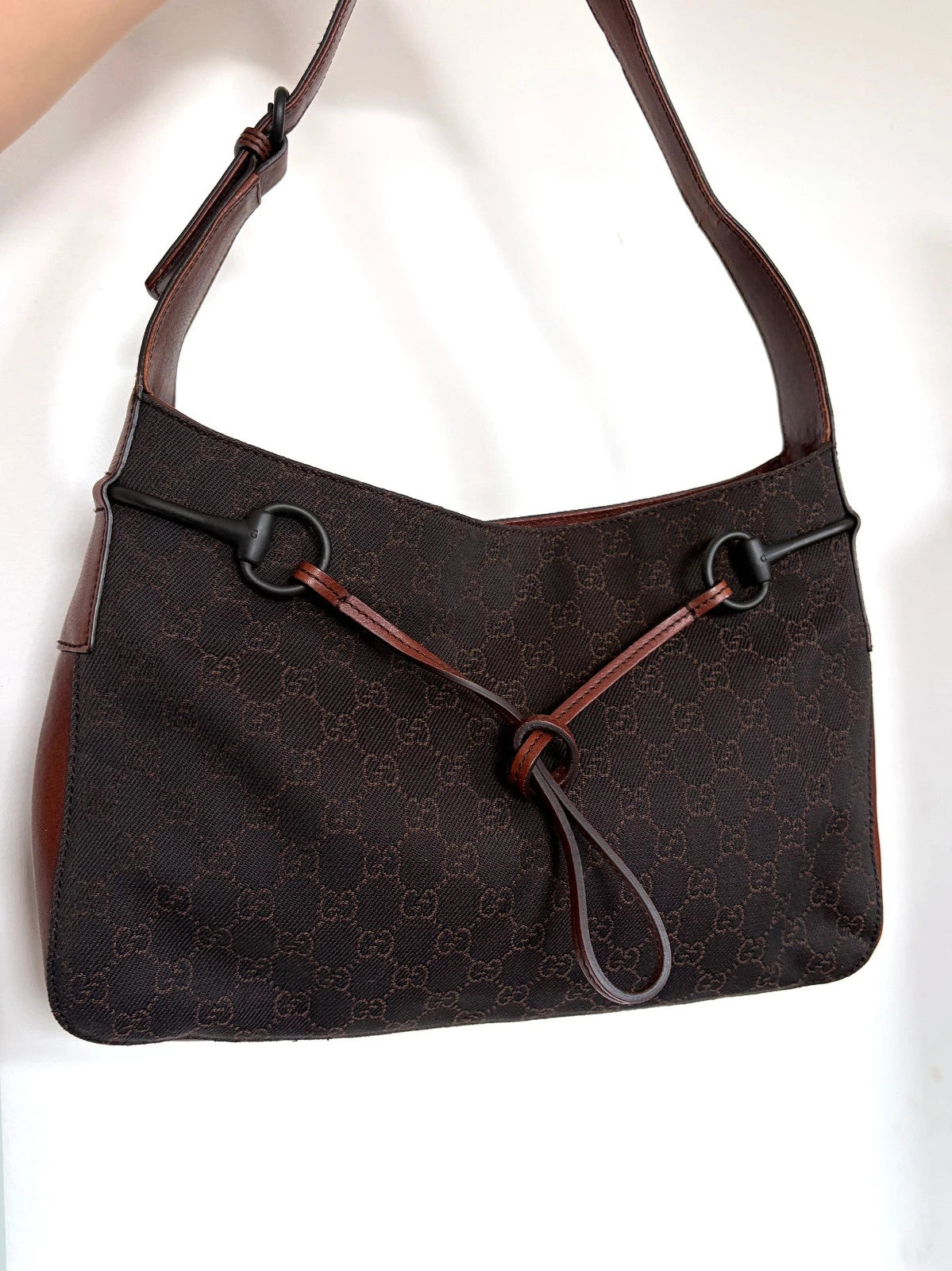 Gucci dark brown hobo bag with GG canvas, Horsebit hardware, and leather trim.