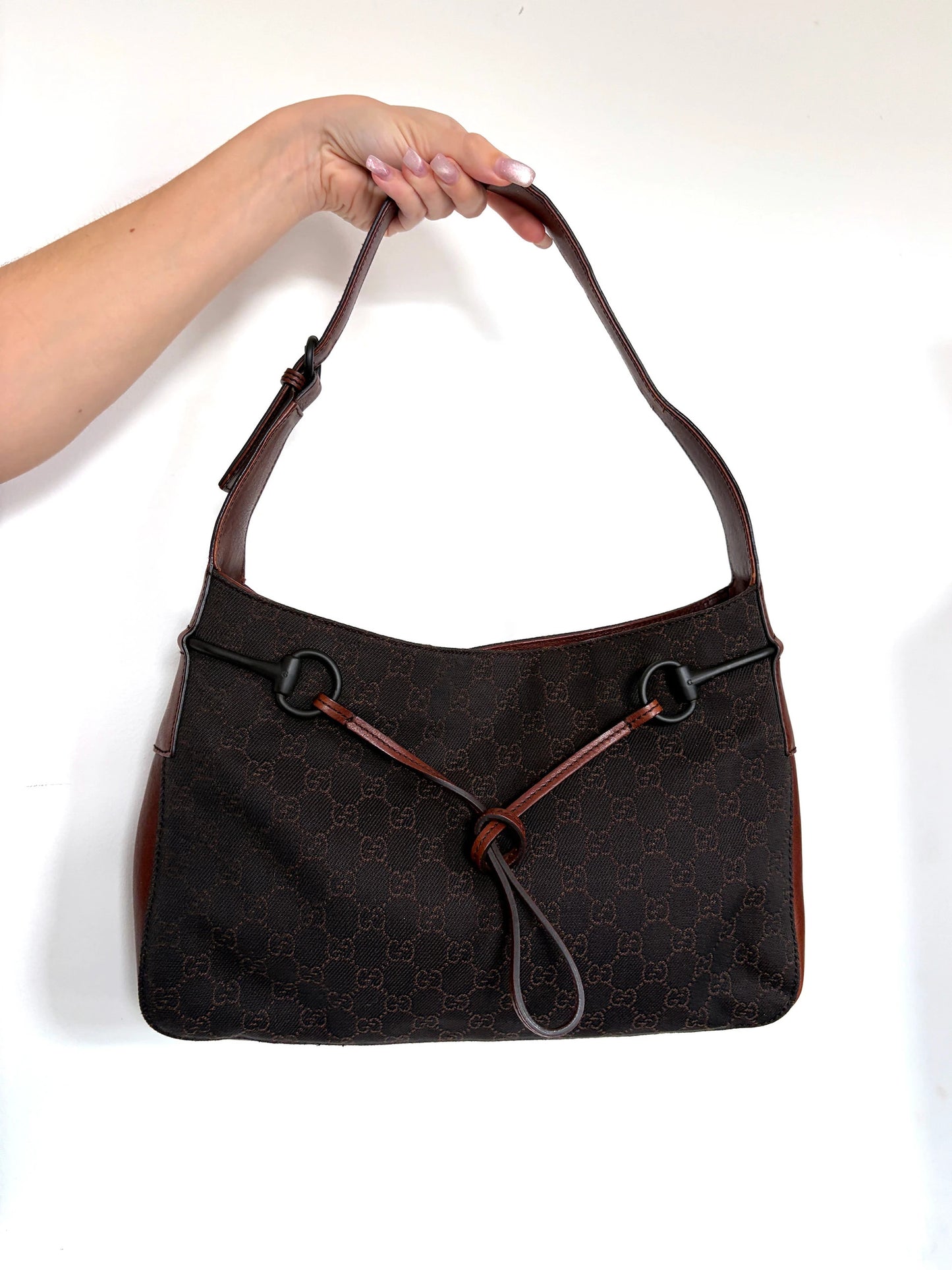 Gucci dark brown hobo bag with GG canvas, Horsebit hardware, and leather trim.