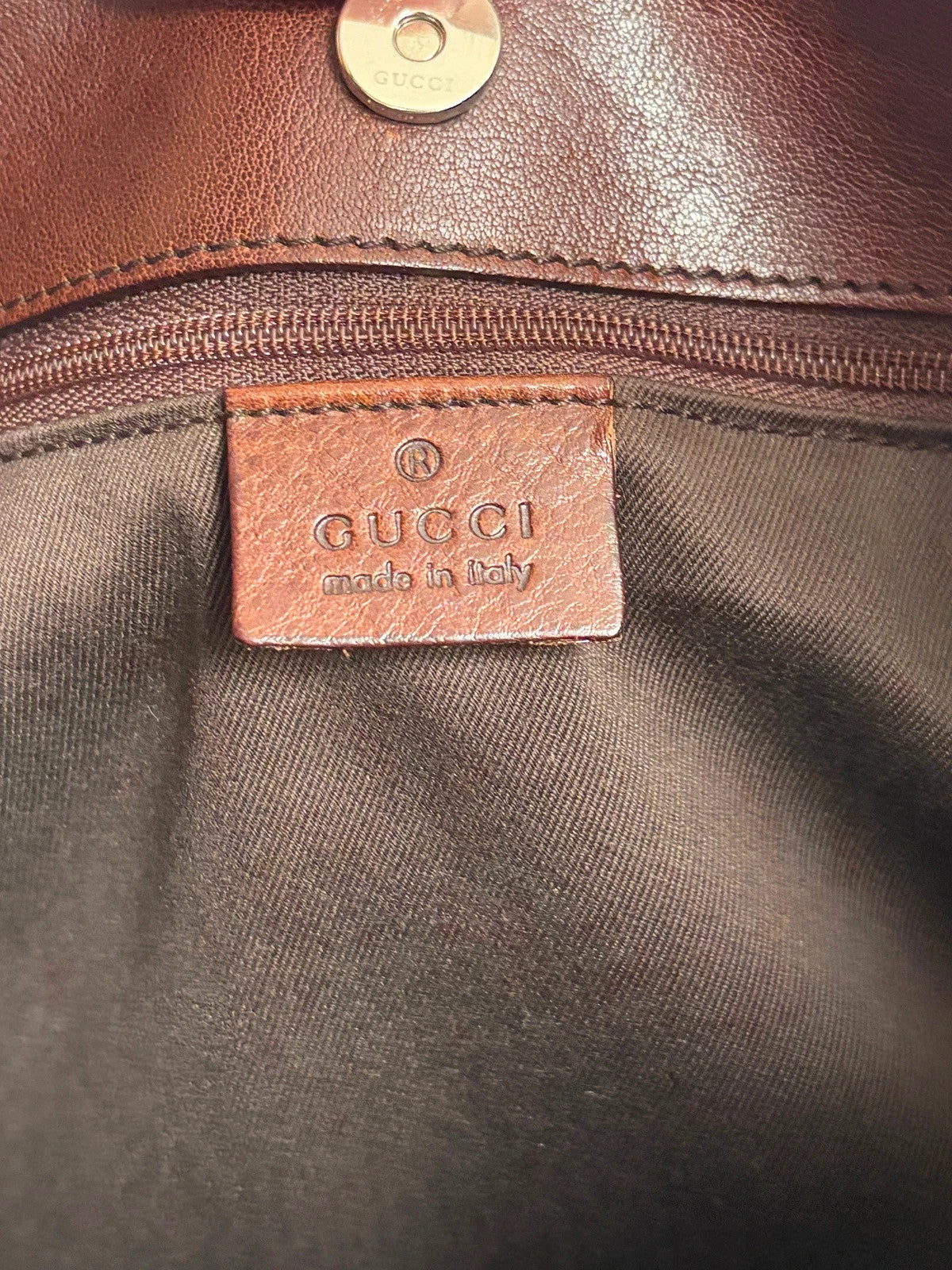 Gucci dark brown hobo bag with GG canvas, Horsebit hardware, and leather trim.