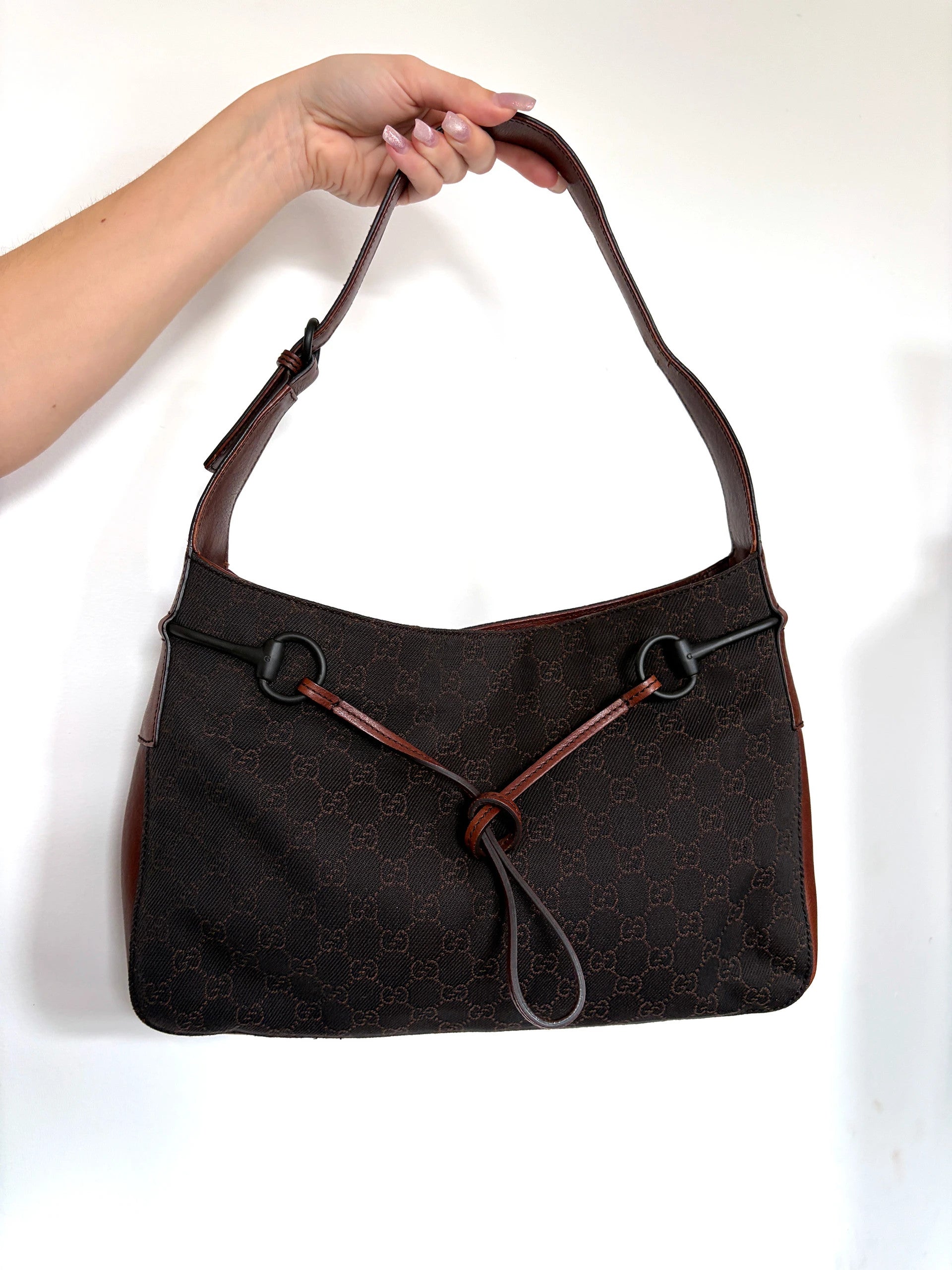 Gucci dark brown hobo bag with GG canvas, Horsebit hardware, and leather trim.