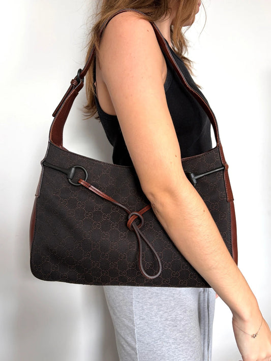Gucci dark brown hobo bag with GG canvas, Horsebit hardware, and leather trim.