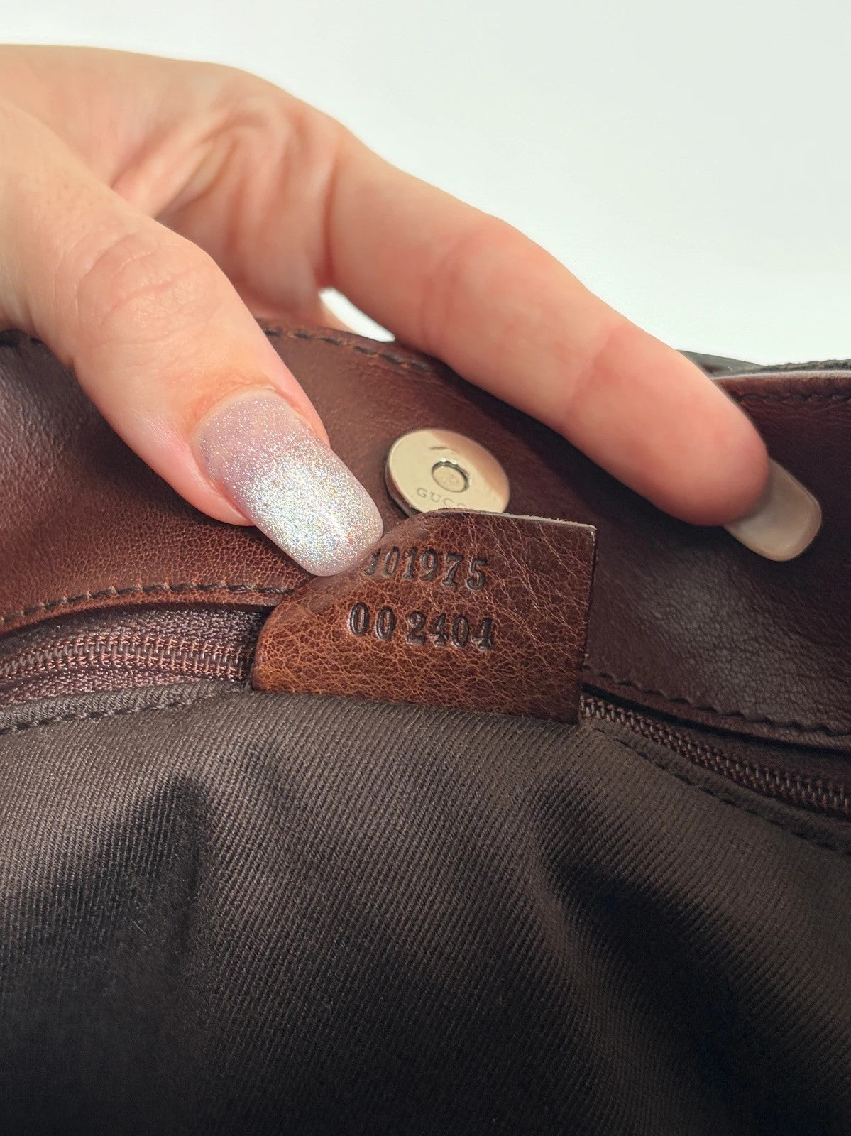 Gucci dark brown hobo bag with GG canvas, Horsebit hardware, and leather trim.