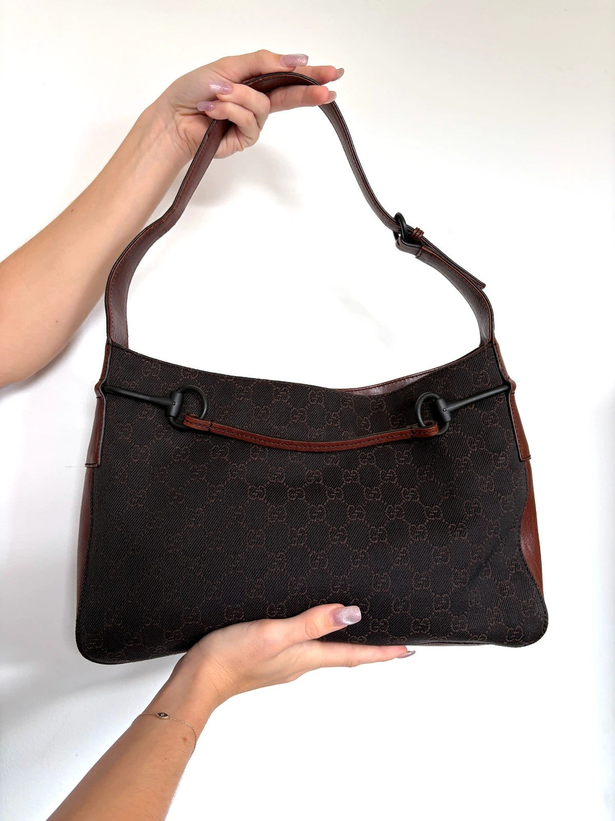 Gucci dark brown hobo bag with GG canvas, Horsebit hardware, and leather trim.