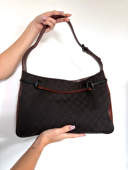Gucci dark brown hobo bag with GG canvas, Horsebit hardware, and leather trim.