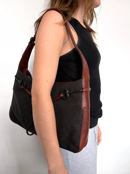 Gucci dark brown hobo bag with GG canvas, Horsebit hardware, and leather trim.