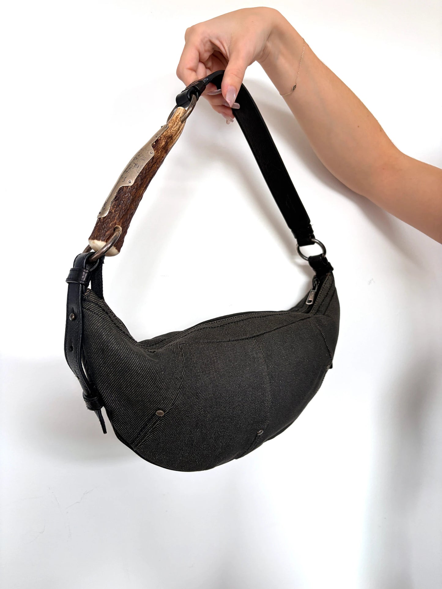Yves Saint Laurent black Mombasa sling bag with YSL Cassandre logo and silver-tone details.