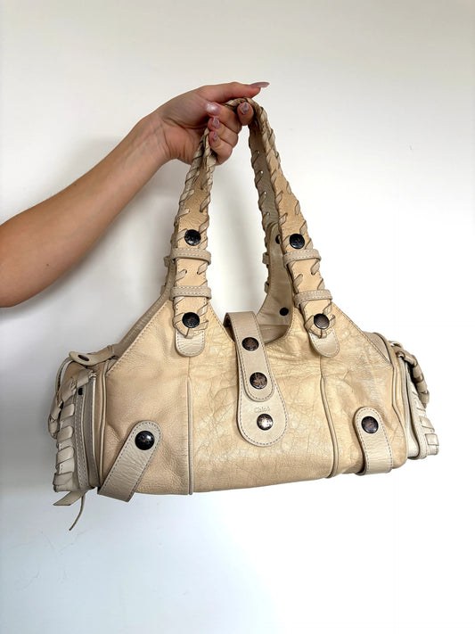Chloé cream leather Silverado bag with braided handles and oxidized gunmetal studs.
