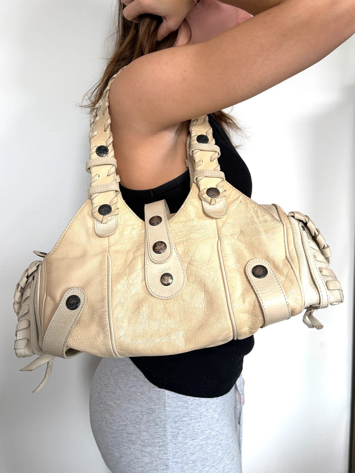 Chloé cream leather Silverado bag with braided handles and oxidized gunmetal studs.