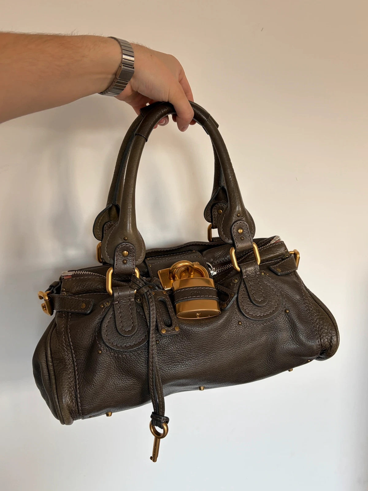 Chloé green leather Paddington bag with brass hardware and engraved padlock detail.