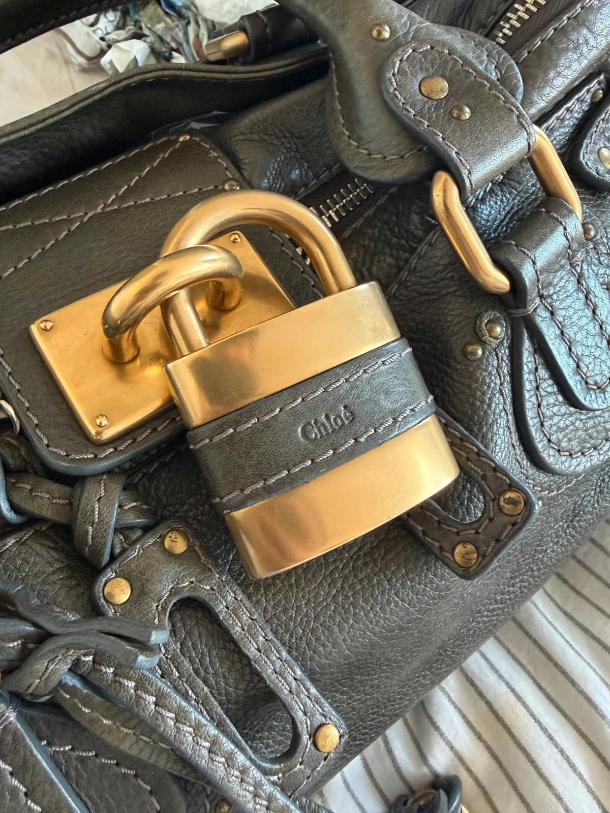 Chloé green leather Paddington bag with brass hardware and engraved padlock detail.