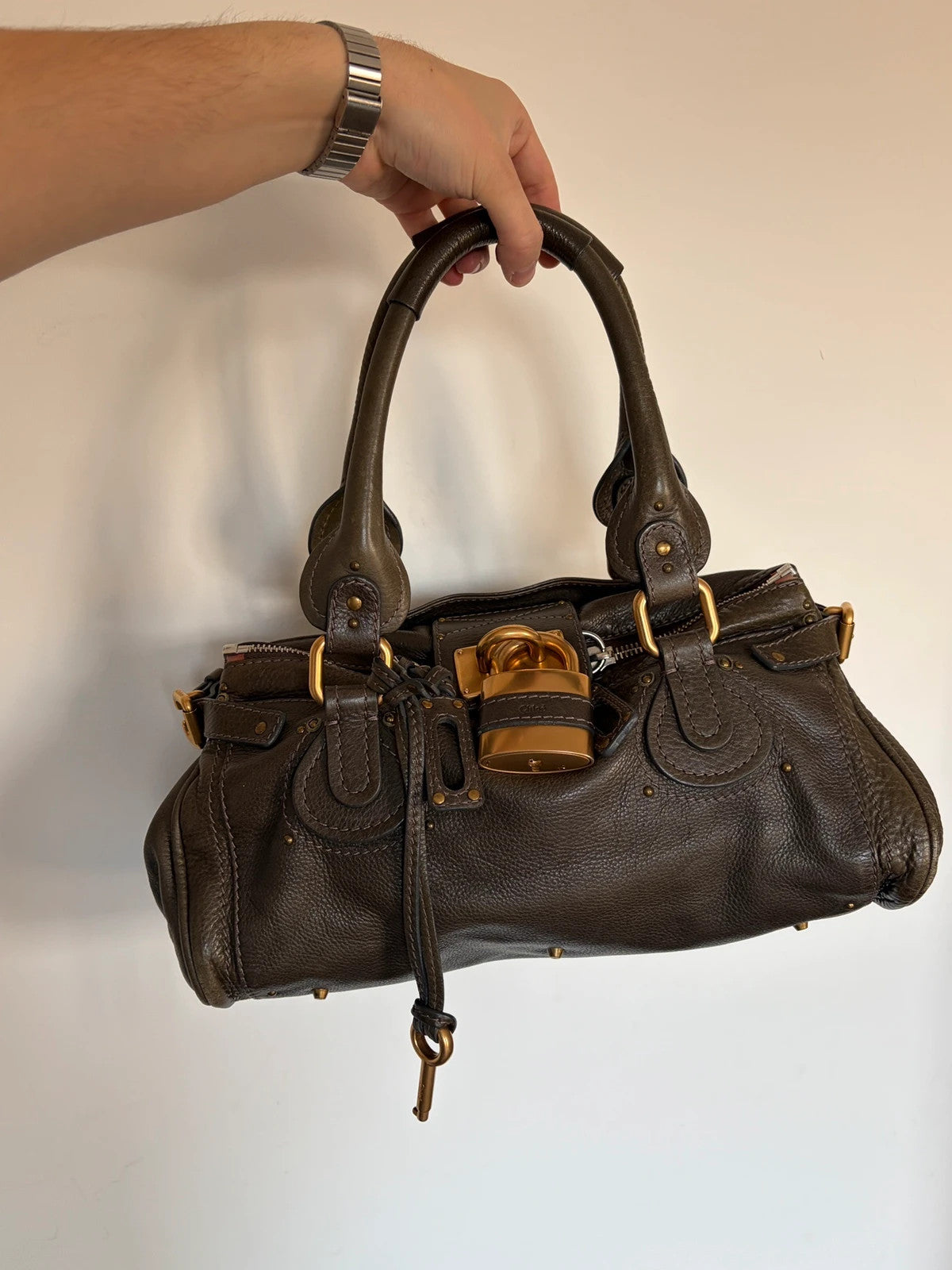 Chloé green leather Paddington bag with brass hardware and engraved padlock detail.