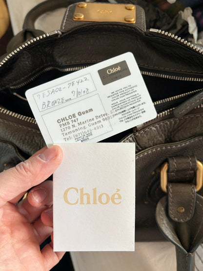 Chloé green leather Paddington bag with brass hardware and engraved padlock detail.