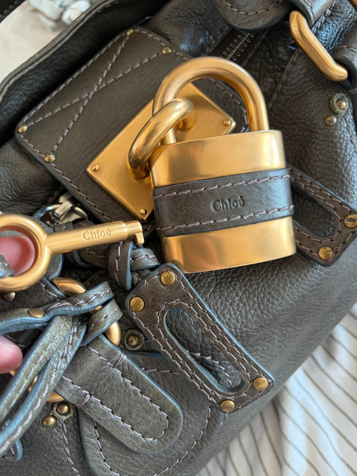 Chloé green leather Paddington bag with brass hardware and engraved padlock detail.