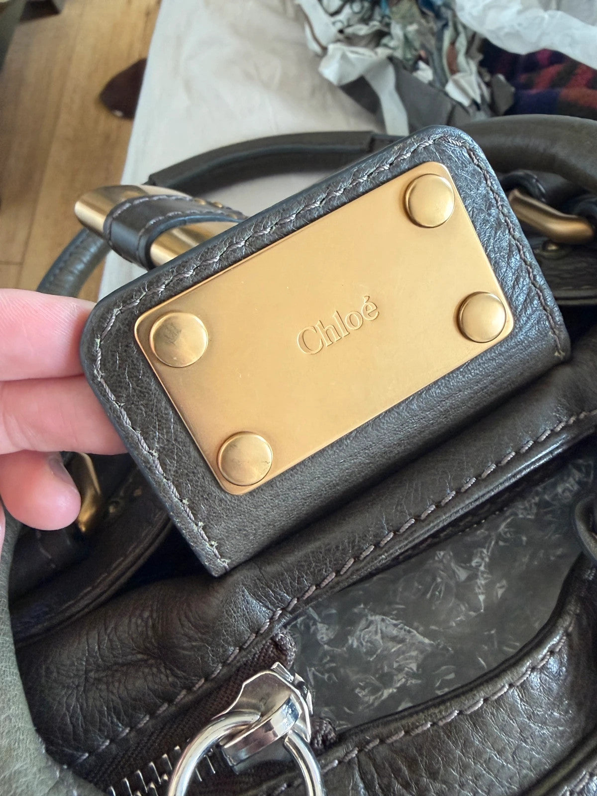 Chloé green leather Paddington bag with brass hardware and engraved padlock detail.