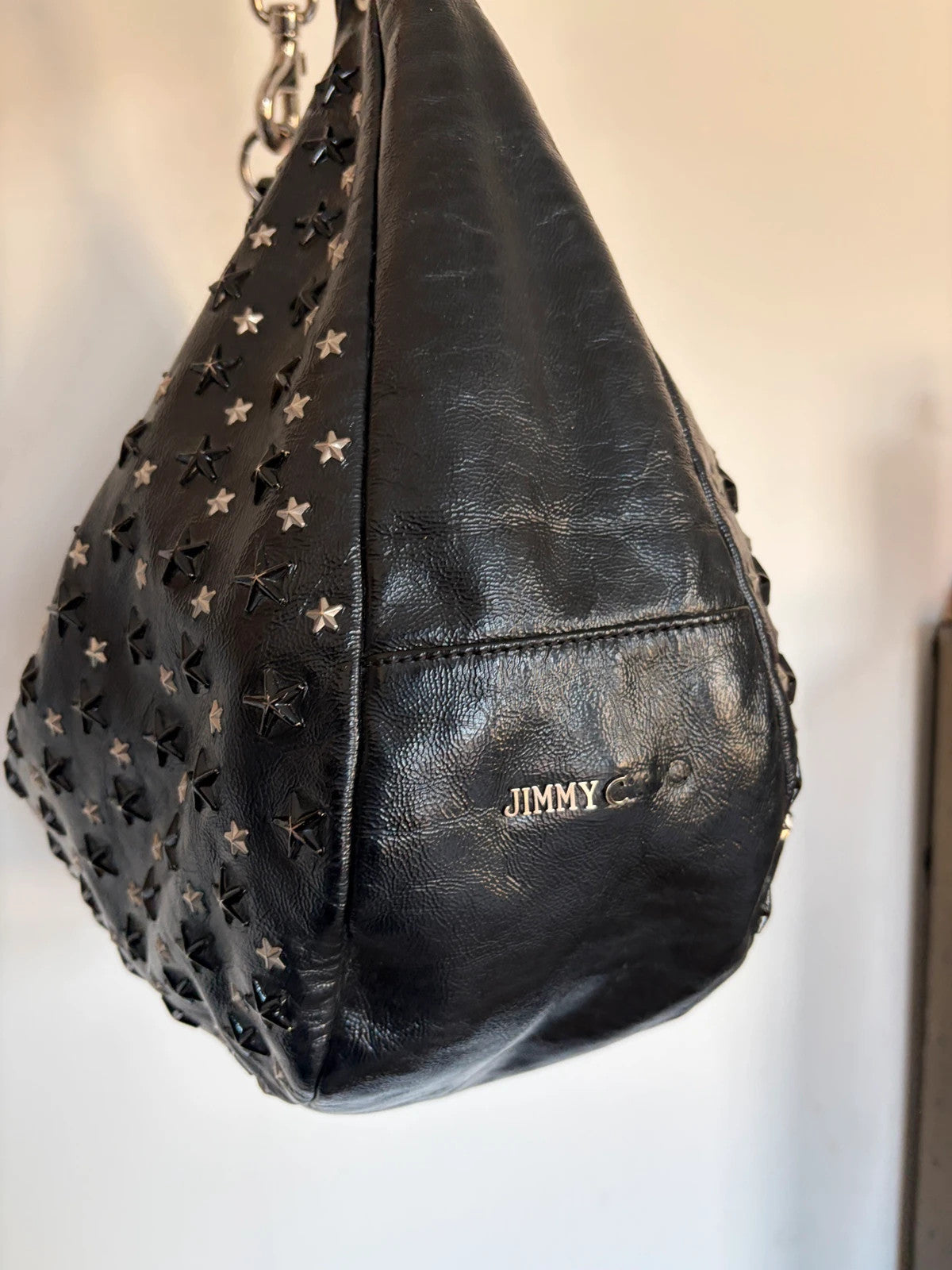 Jimmy Choo black shopping tote with star embellishments and authenticity card.