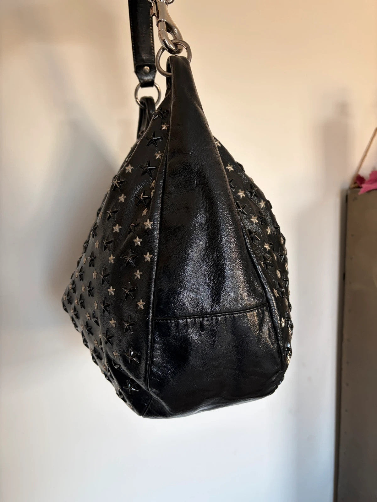 Jimmy Choo black shopping tote with star embellishments and authenticity card.