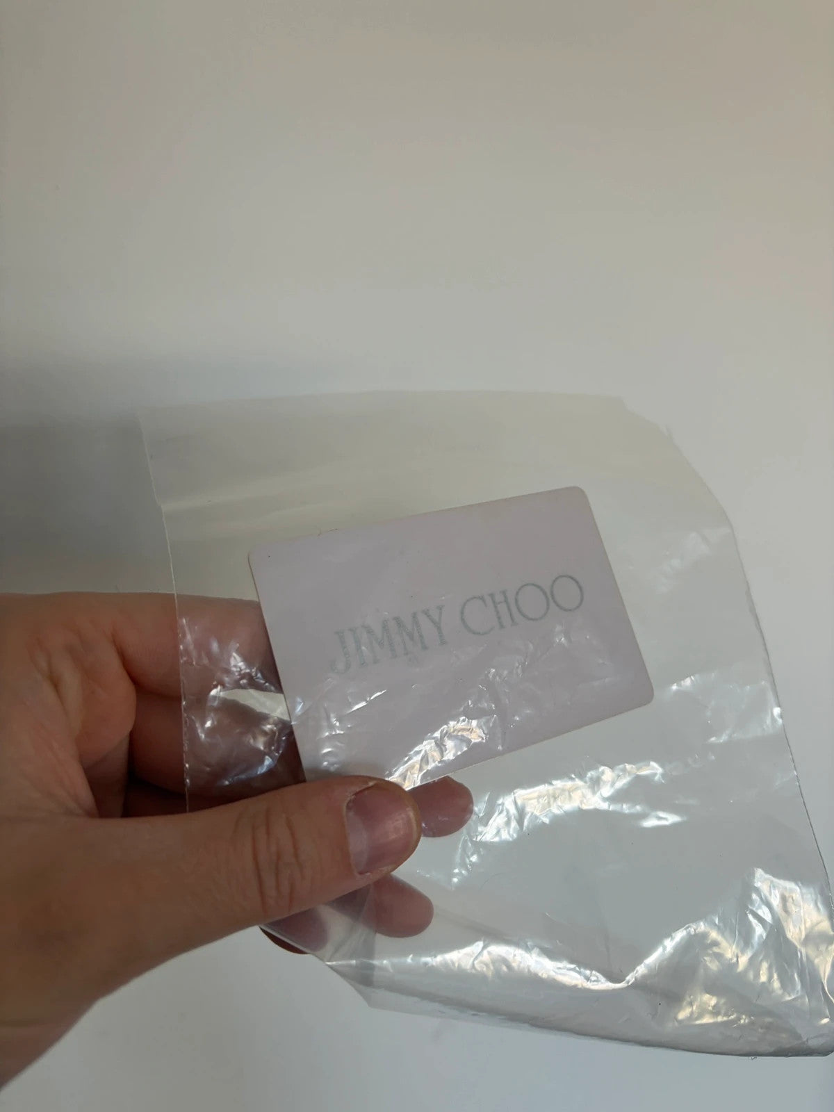 Jimmy Choo black shopping tote with star embellishments and authenticity card.
