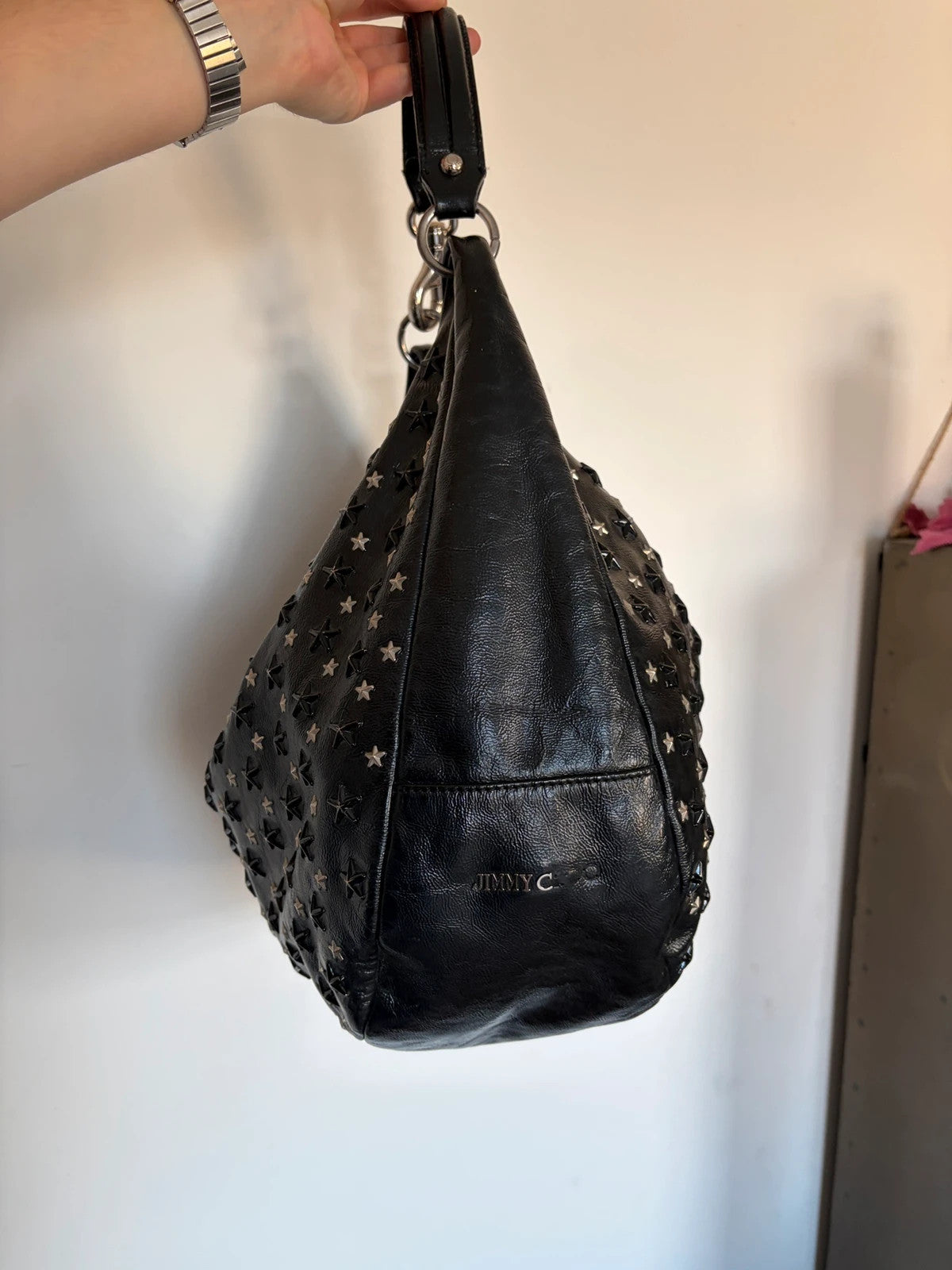 Jimmy Choo black shopping tote with star embellishments and authenticity card.