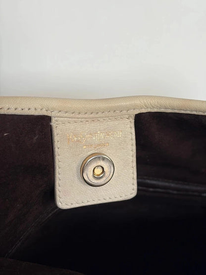 Yves Saint Laurent cream leather hobo bag with tiered ruffles and gold-tone logo plaque.