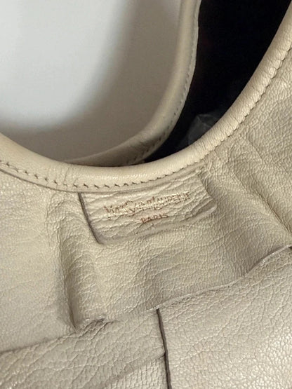 Yves Saint Laurent cream leather hobo bag with tiered ruffles and gold-tone logo plaque.