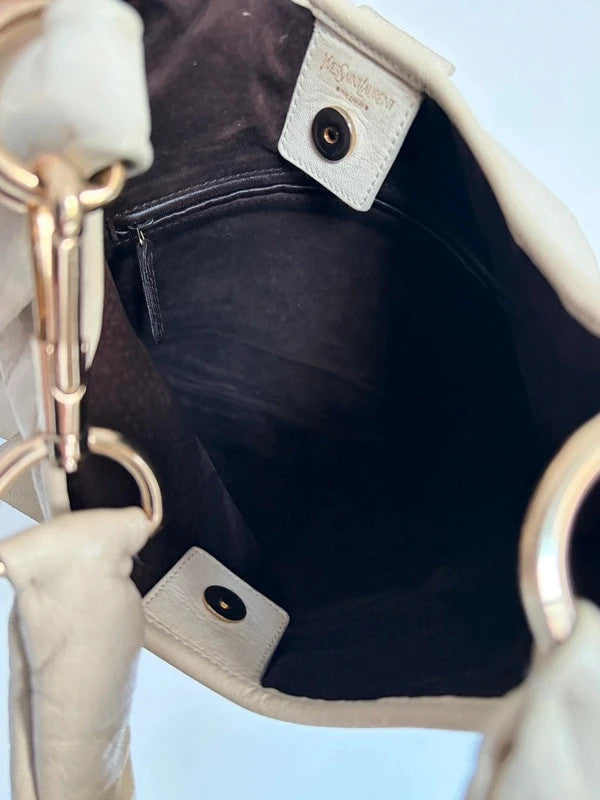 Yves Saint Laurent cream leather hobo bag with tiered ruffles and gold-tone logo plaque.