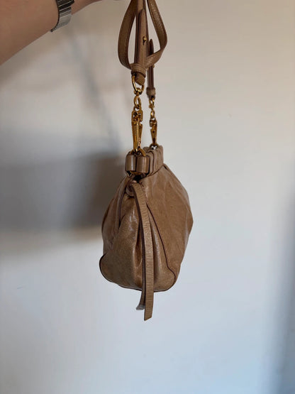 Miu Miu taupe mini crossbody bag with ruched collar, gold lettering, and leather strap.