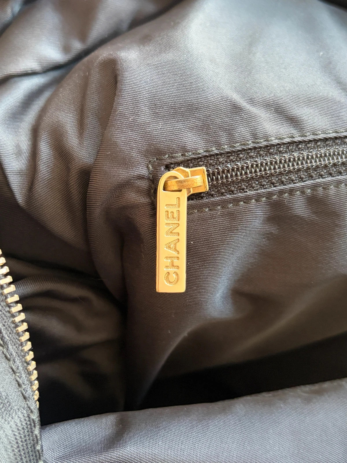 Chanel black shopping tote with CC jacquard pattern and leather shoulder handles.