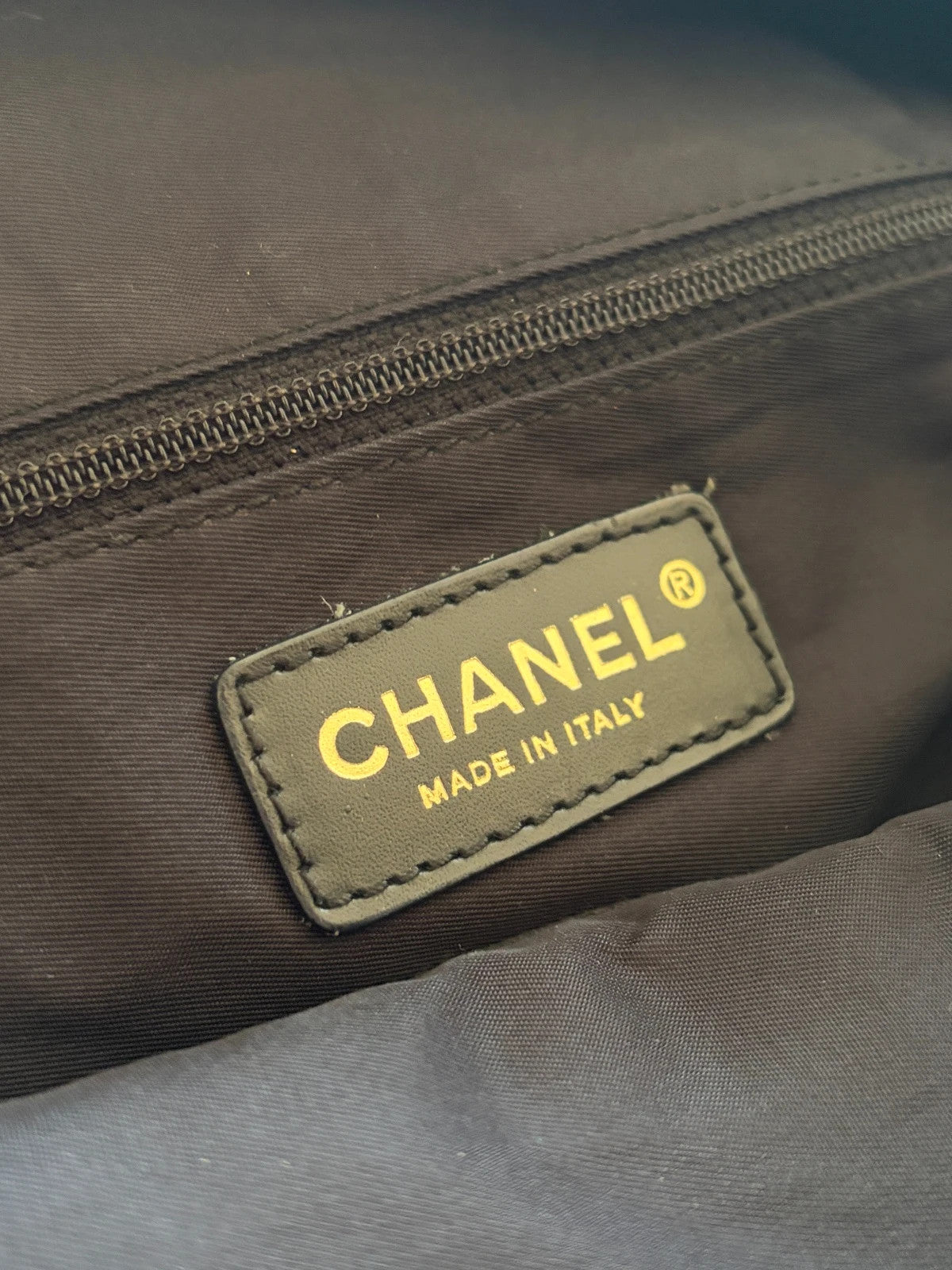 Chanel black shopping tote with CC jacquard pattern and leather shoulder handles.